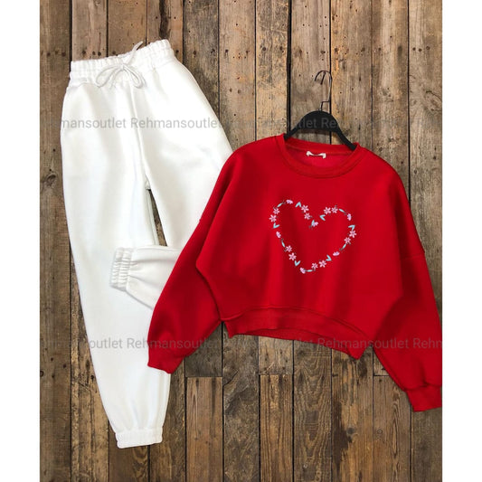 Red sweatshirt with colourful heart and white trouser