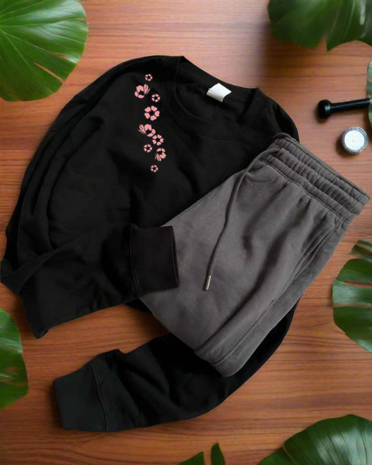 Black sweatshirt with shoulder pink flowers charcoal trouser
