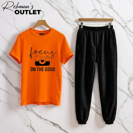 orange tee with focus on the good black trouser
